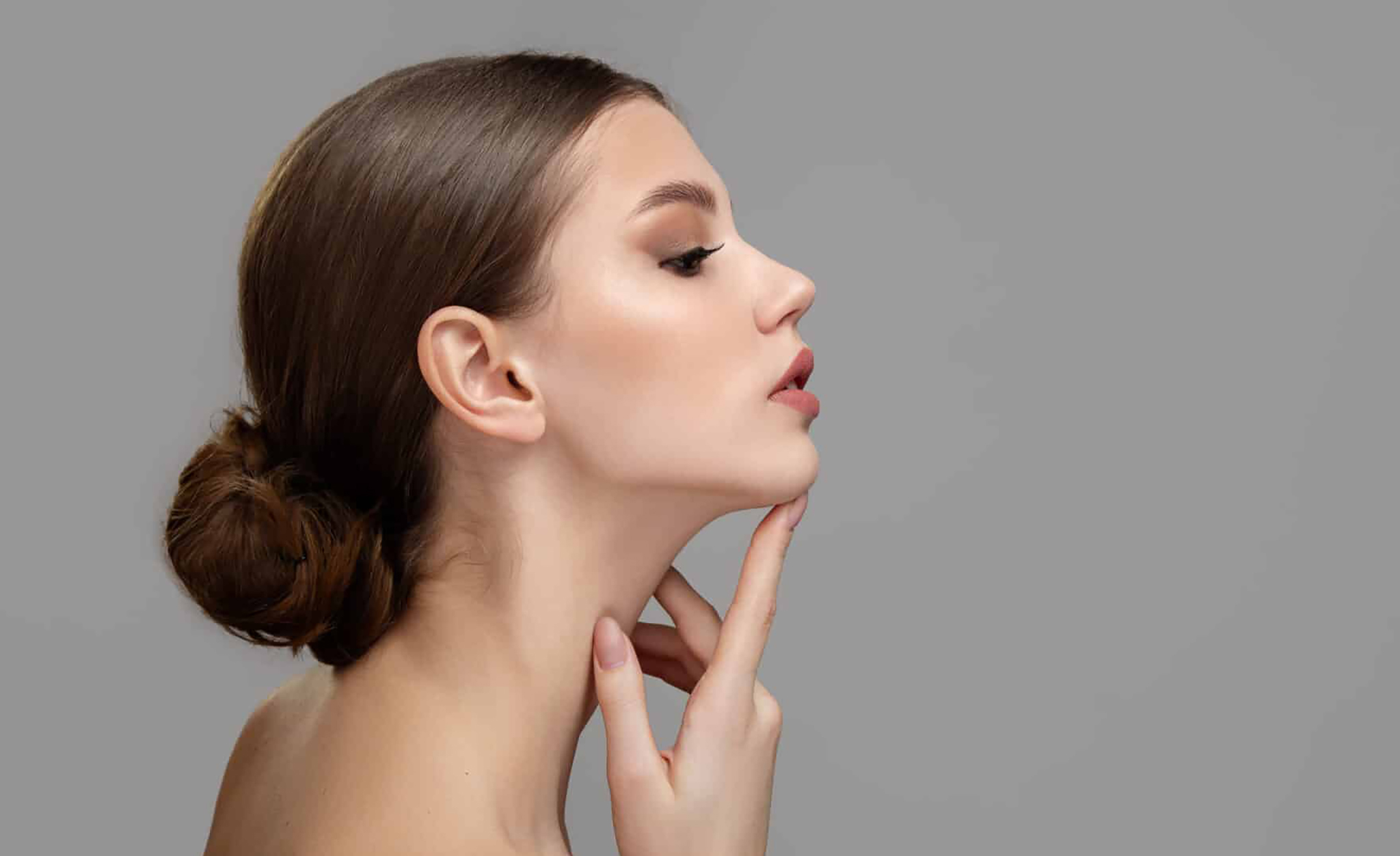 Woman face profile side view. Chin lift pointing with index finger